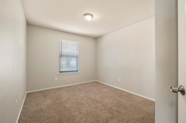 unfurnished room featuring carpet