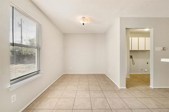 tiled spare room with a healthy amount of sunlight