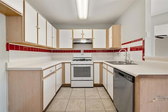 kitchen featuring white gas stove, sink, dishwasher, backsplash, and light tile patterned floors