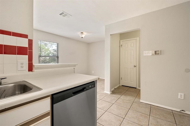 kitchen featuring dishwasher, light tile patterned flooring, and sink