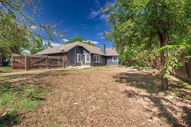 rear view of house with a yard