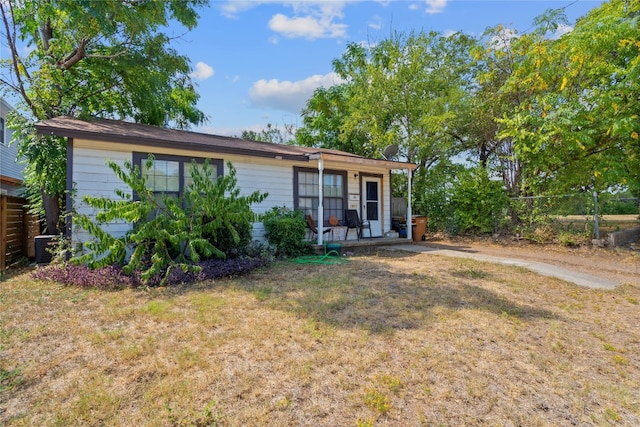 rear view of house with a lawn