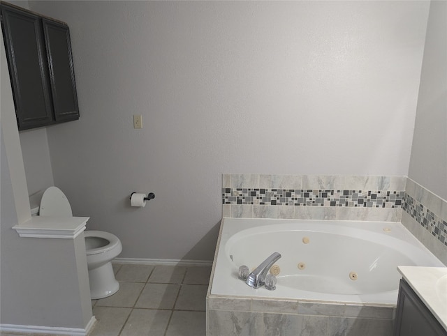 bathroom featuring tiled bath, toilet, vanity, and tile patterned floors