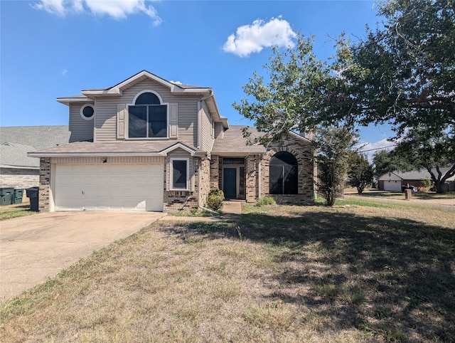 view of front of house featuring a front lawn and a garage