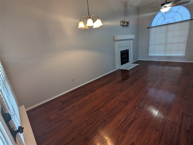 unfurnished living room featuring a fireplace, dark hardwood / wood-style flooring, and a healthy amount of sunlight