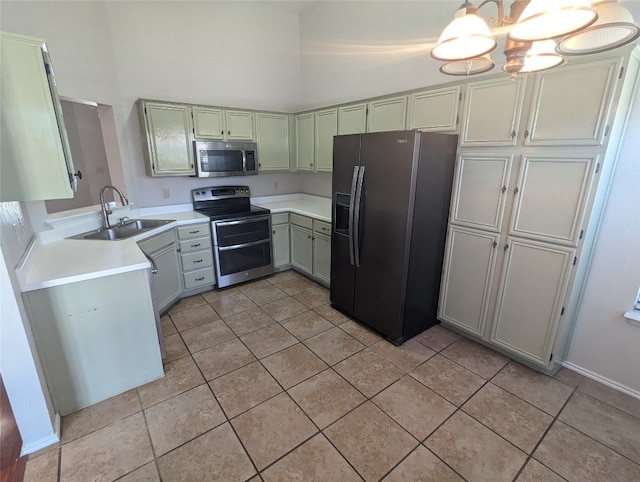 kitchen featuring a chandelier, appliances with stainless steel finishes, light tile patterned flooring, and sink