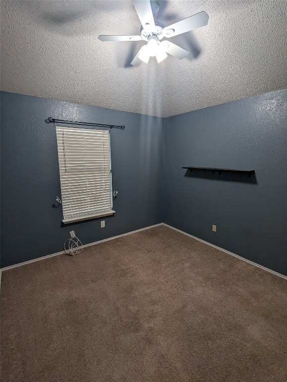 unfurnished room with a textured ceiling, ceiling fan, and carpet floors