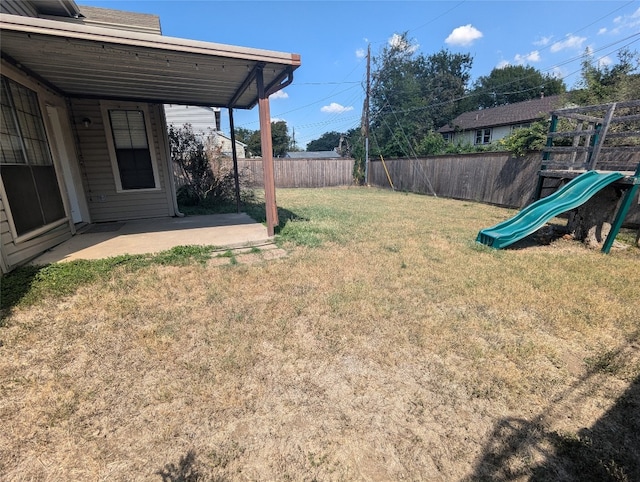 view of yard with a patio and a playground