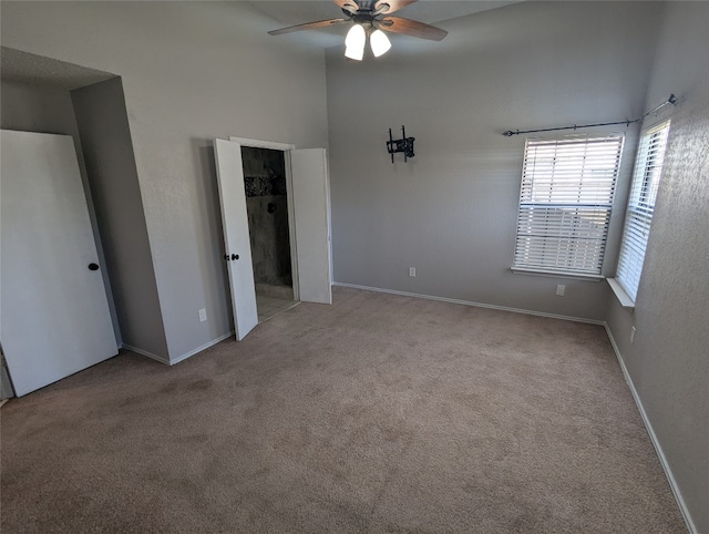 unfurnished bedroom featuring ceiling fan, a closet, and light carpet