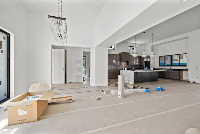 interior space featuring an inviting chandelier and a high ceiling