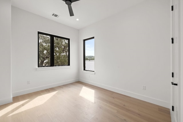 spare room featuring light hardwood / wood-style flooring and ceiling fan