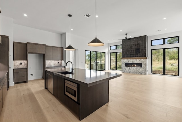 kitchen featuring appliances with stainless steel finishes, sink, plenty of natural light, and pendant lighting