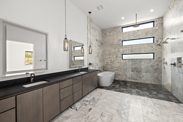 bathroom featuring vanity, a healthy amount of sunlight, plus walk in shower, and tile walls