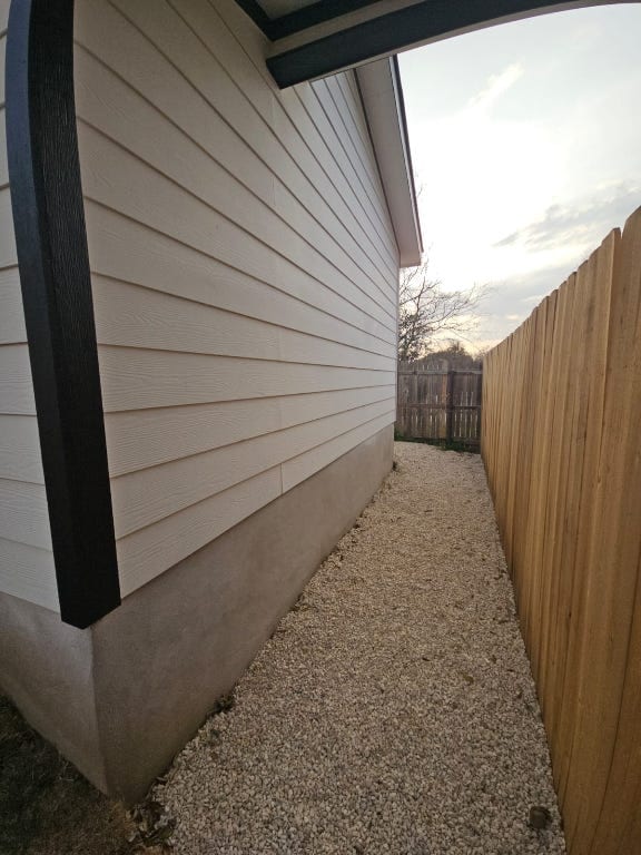 view of home's exterior with fence