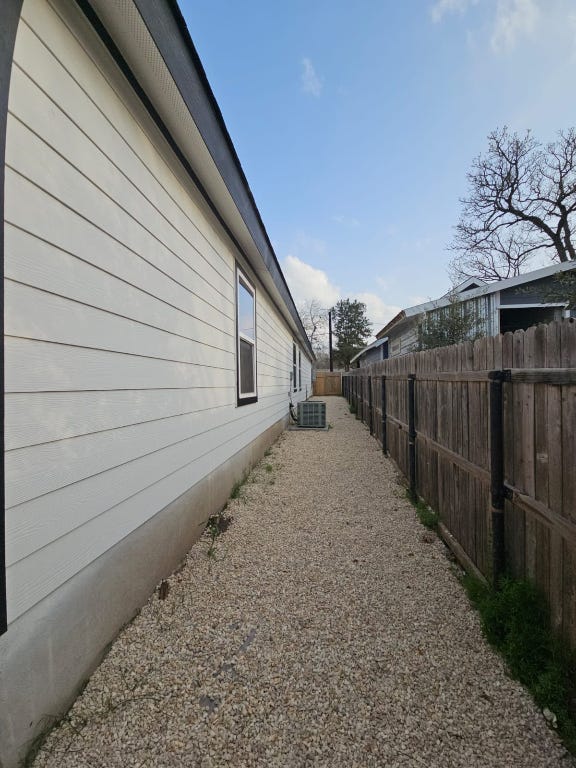 view of home's exterior featuring central AC and a fenced backyard