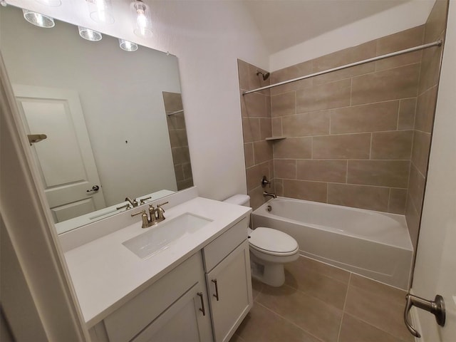 full bathroom with tile patterned floors, toilet, tiled shower / bath combo, and vanity