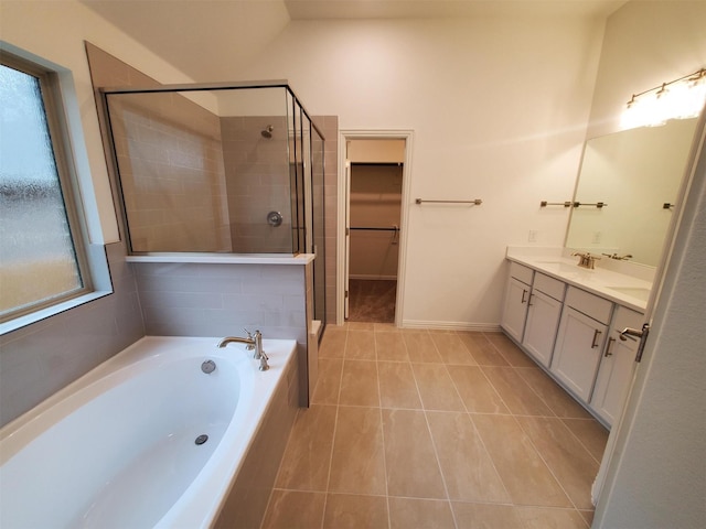 bathroom featuring vanity, tile patterned flooring, and separate shower and tub