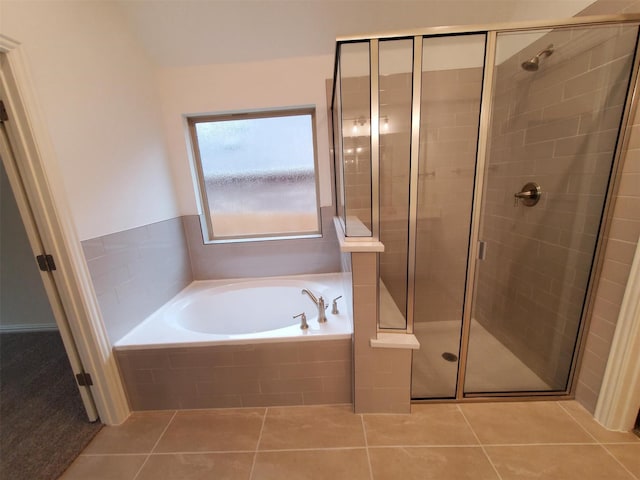 bathroom with tile patterned flooring and shower with separate bathtub