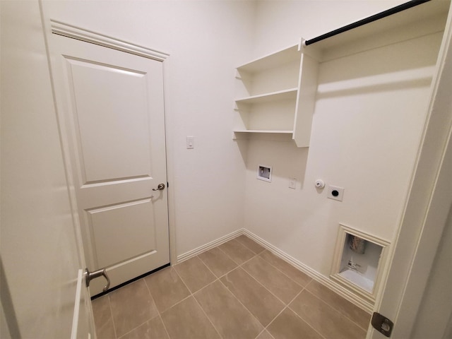 washroom featuring gas dryer hookup, washer hookup, light tile patterned flooring, and electric dryer hookup