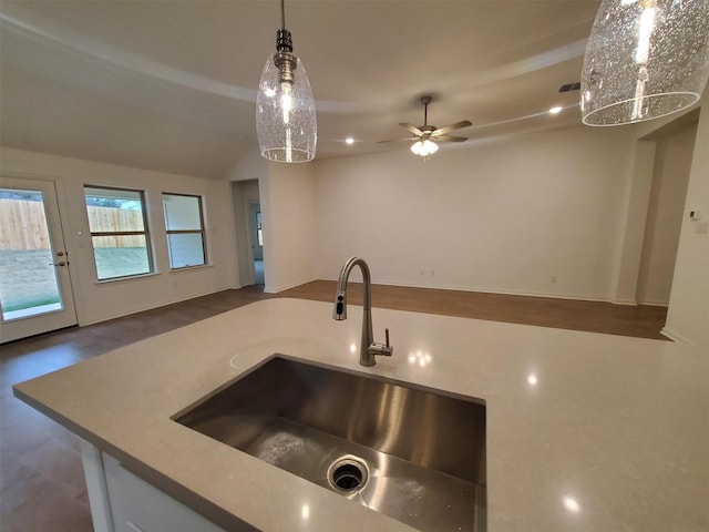 kitchen with pendant lighting, sink, lofted ceiling, and ceiling fan