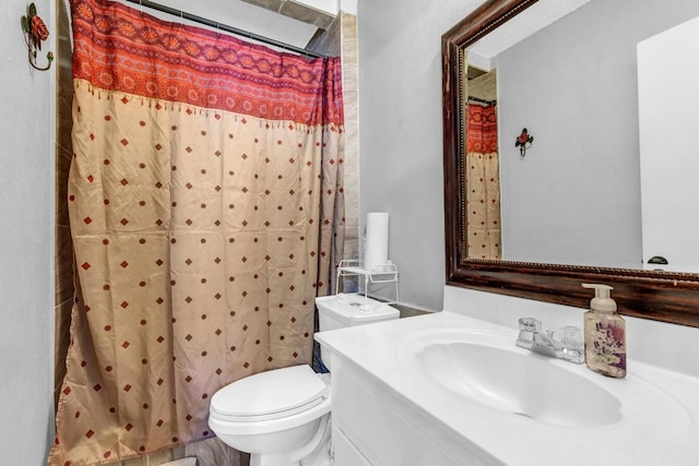 bathroom featuring walk in shower, vanity, and toilet