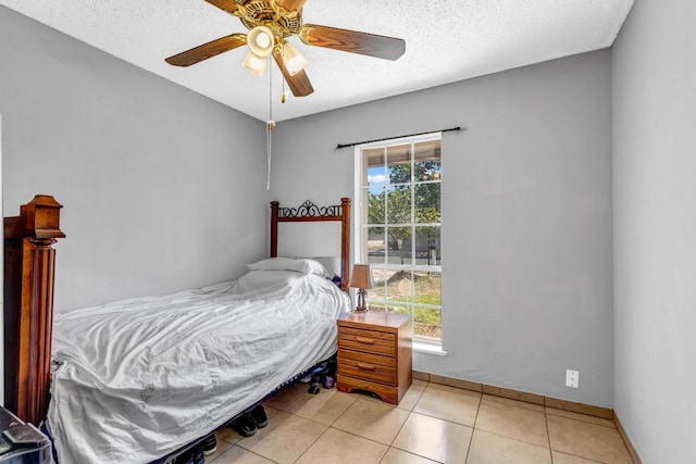 bedroom featuring multiple windows, a textured ceiling, and ceiling fan