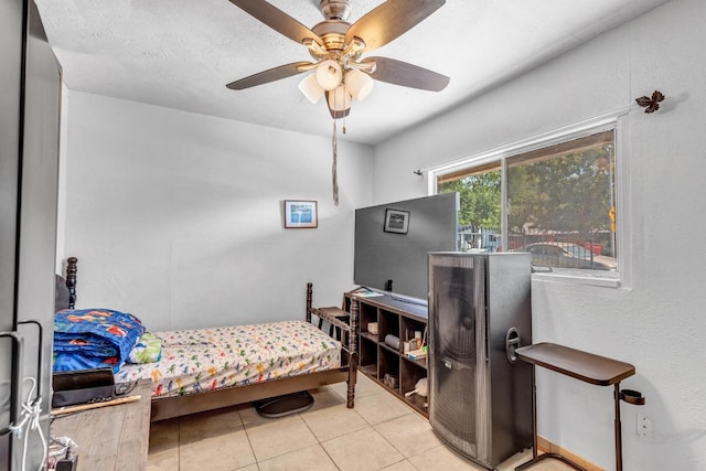 tiled bedroom featuring ceiling fan