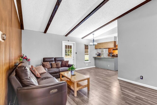 living room with lofted ceiling with beams, a textured ceiling, and dark wood-type flooring