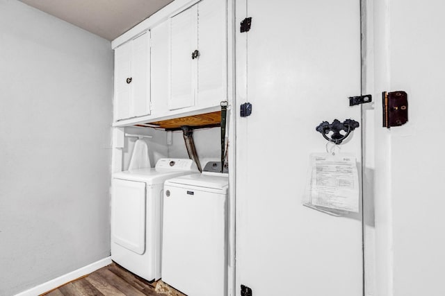 washroom with cabinets, dark hardwood / wood-style floors, and washing machine and clothes dryer