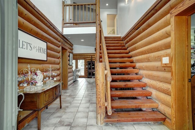 stairs with log walls and tile patterned floors