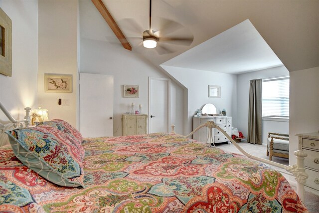 carpeted bedroom with vaulted ceiling with beams and ceiling fan