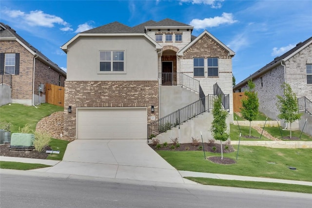 1425 Cole Estates Dr, Georgetown, TX 78628 - view of front of home with driveway, an attached garage, a front lawn, stucco siding, and brick siding