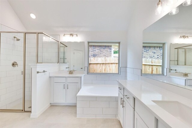 1425 Cole Estates Dr, Georgetown, TX 78628 - full bathroom featuring a stall shower, two vanities, a bath, and tile patterned floors
