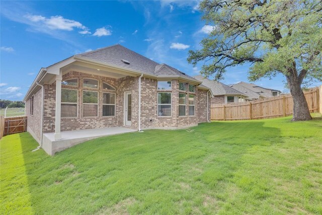 1425 Cole Estates Dr, Georgetown, TX 78628 - back of house with brick siding, a patio, and roof with shingles
