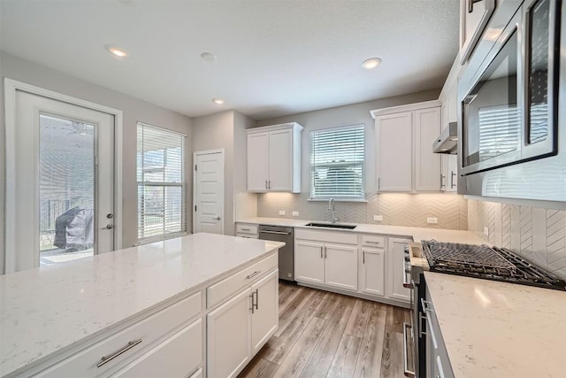 kitchen featuring white cabinets, light stone countertops, sink, and stainless steel appliances