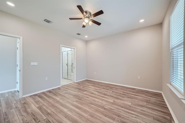 spare room featuring light hardwood / wood-style flooring and ceiling fan