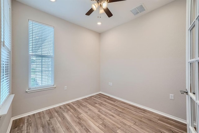 spare room with light hardwood / wood-style floors and ceiling fan