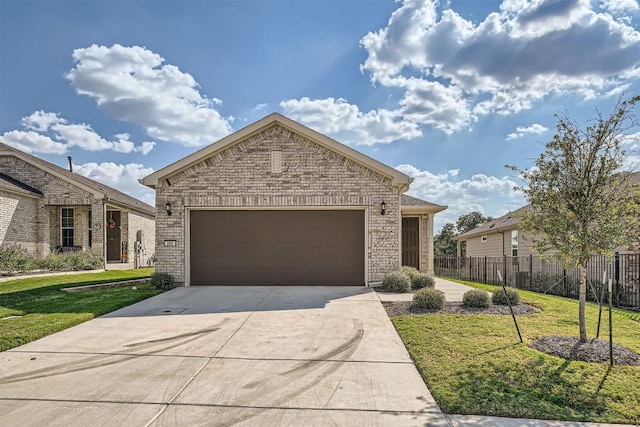 view of front of property featuring a front yard and a garage