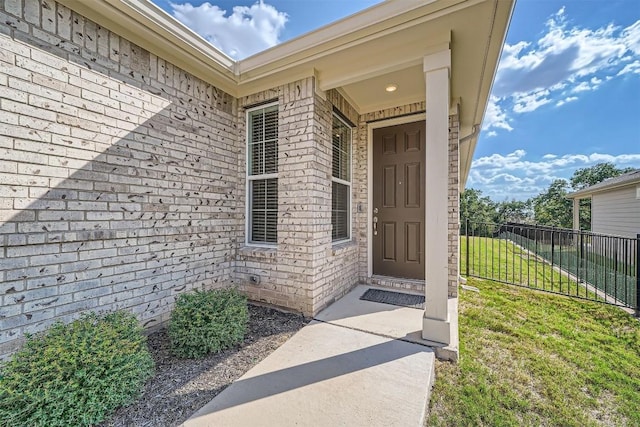 doorway to property with a yard