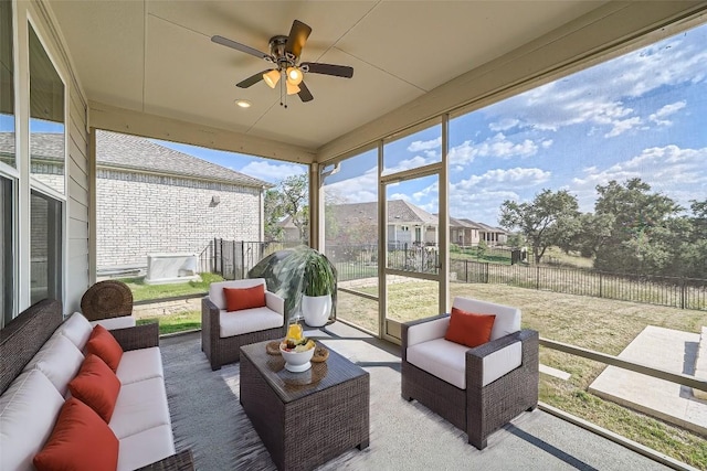 sunroom / solarium featuring ceiling fan