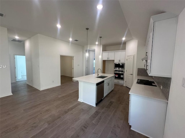 kitchen with white cabinetry, sink, stainless steel appliances, pendant lighting, and a center island with sink