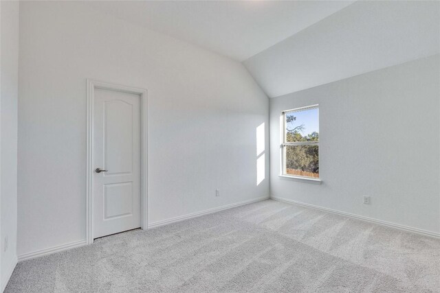 1429 Cole Estates Dr, Georgetown, TX 78628 - empty room featuring carpet flooring, vaulted ceiling, and baseboards