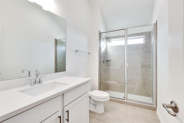 bathroom featuring vanity, tile patterned flooring, a shower with door, and toilet