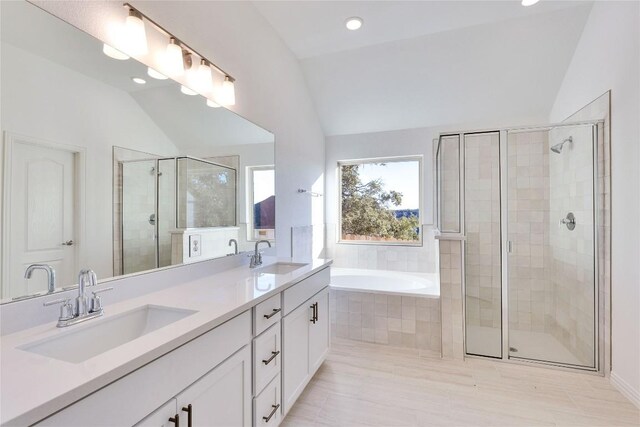 1429 Cole Estates Dr, Georgetown, TX 78628 - full bathroom featuring vaulted ceiling, a stall shower, a garden tub, double vanity, and recessed lighting