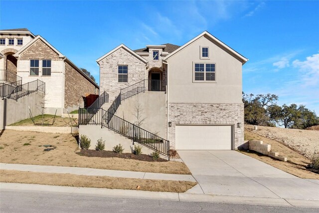 1429 Cole Estates Dr, Georgetown, TX 78628 - view of front of house featuring a garage, stairs, concrete driveway, and stucco siding