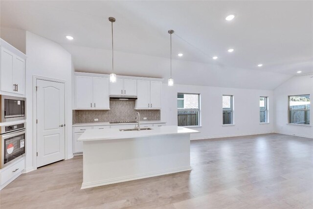 1429 Cole Estates Dr, Georgetown, TX 78628 - kitchen with lofted ceiling, stainless steel oven, built in microwave, a sink, and light countertops