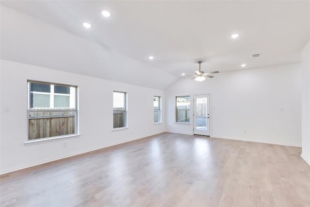 empty room featuring light hardwood / wood-style flooring, ceiling fan, and vaulted ceiling