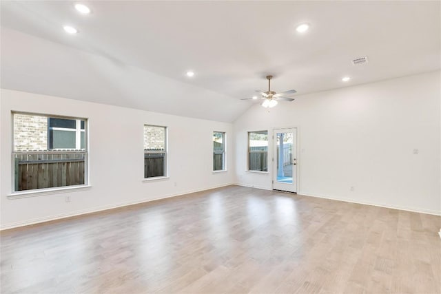 empty room featuring lofted ceiling, ceiling fan, and light hardwood / wood-style flooring