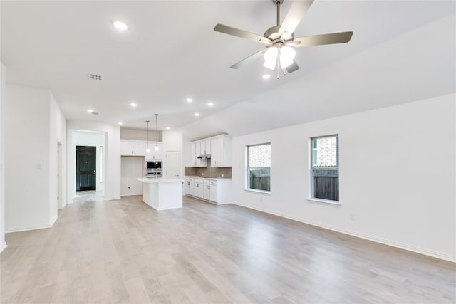 unfurnished living room featuring ceiling fan and light wood-type flooring