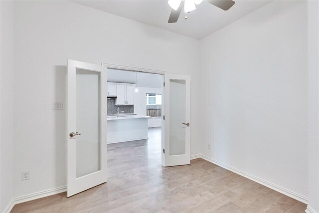 1429 Cole Estates Dr, Georgetown, TX 78628 - spare room with french doors, light wood-type flooring, ceiling fan, and baseboards